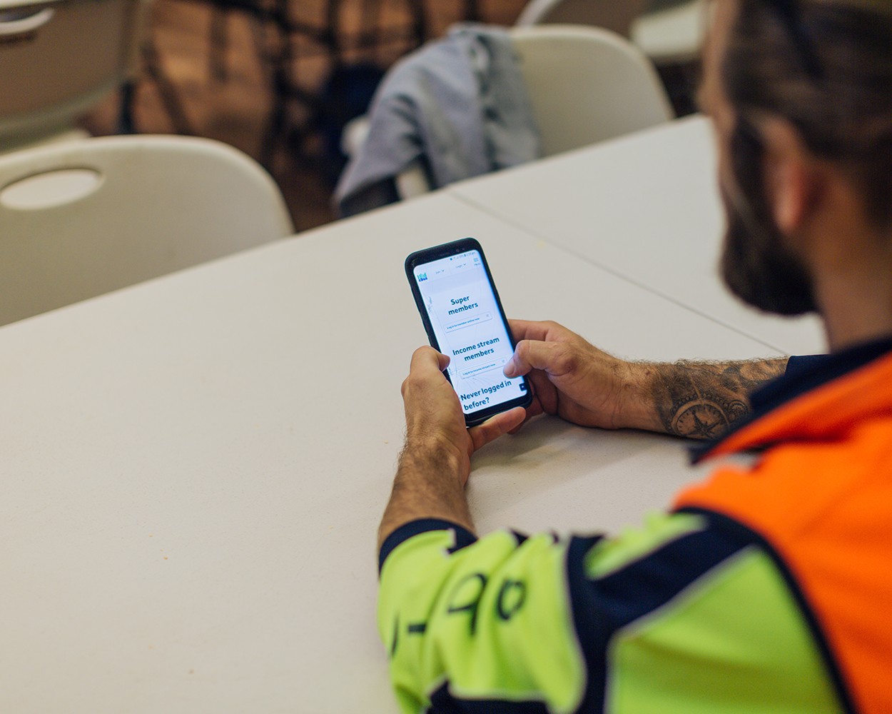 A tradie in the kitchen on the phone